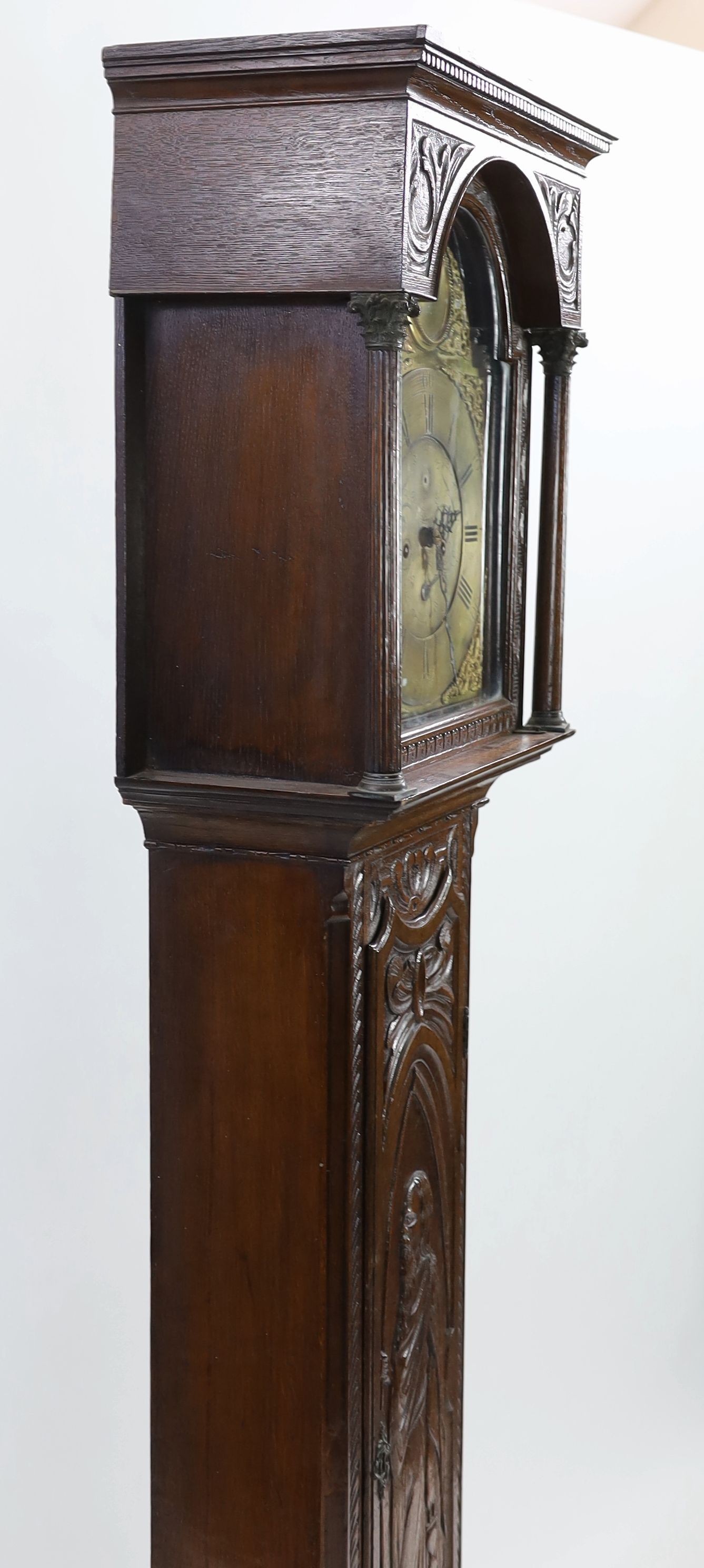 A George III oak eight day longcase clock, the 30cm arched dial marked Arlot, Sunderland, with subsidiary seconds and calendar dials, case 250cm high (later carved)
